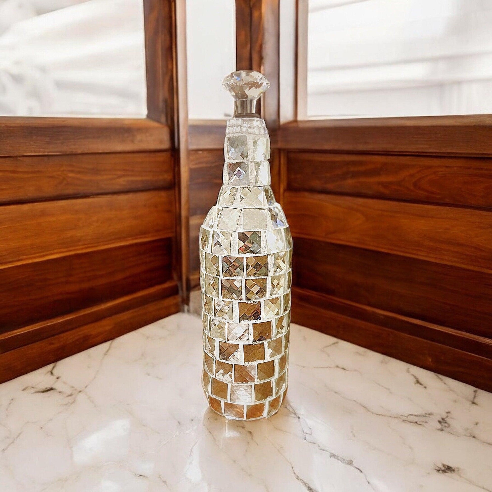 Silver mirrored mosaic wine decanter with intricate mosaic design, reflecting light and adding elegance to wine serving.