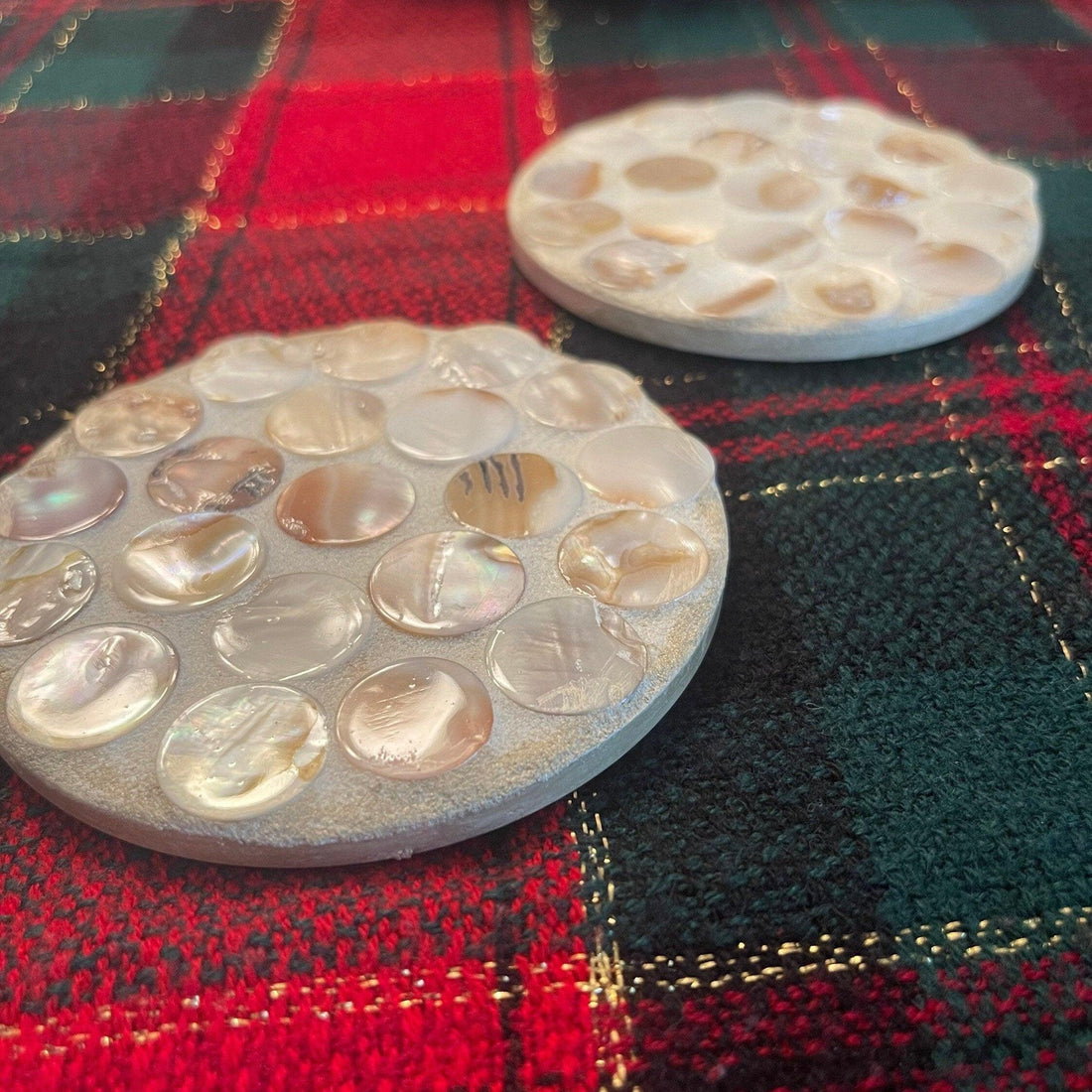 Mother of Pearl mosaic coaster set featuring four elegant coasters with intricate pearl inlay patterns.