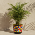 Colorful bouquet in a rainbow mosaic hexagon planter with vibrant flowers and decorative design.