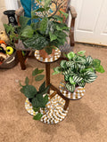 Handcrafted 3-tier mosaic plant stand with colorful tiled shelves and metal frame for indoor or outdoor use.