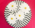 Daisy floral mosaic art cake plate with colorful floral design on ceramic surface, ideal for serving desserts.