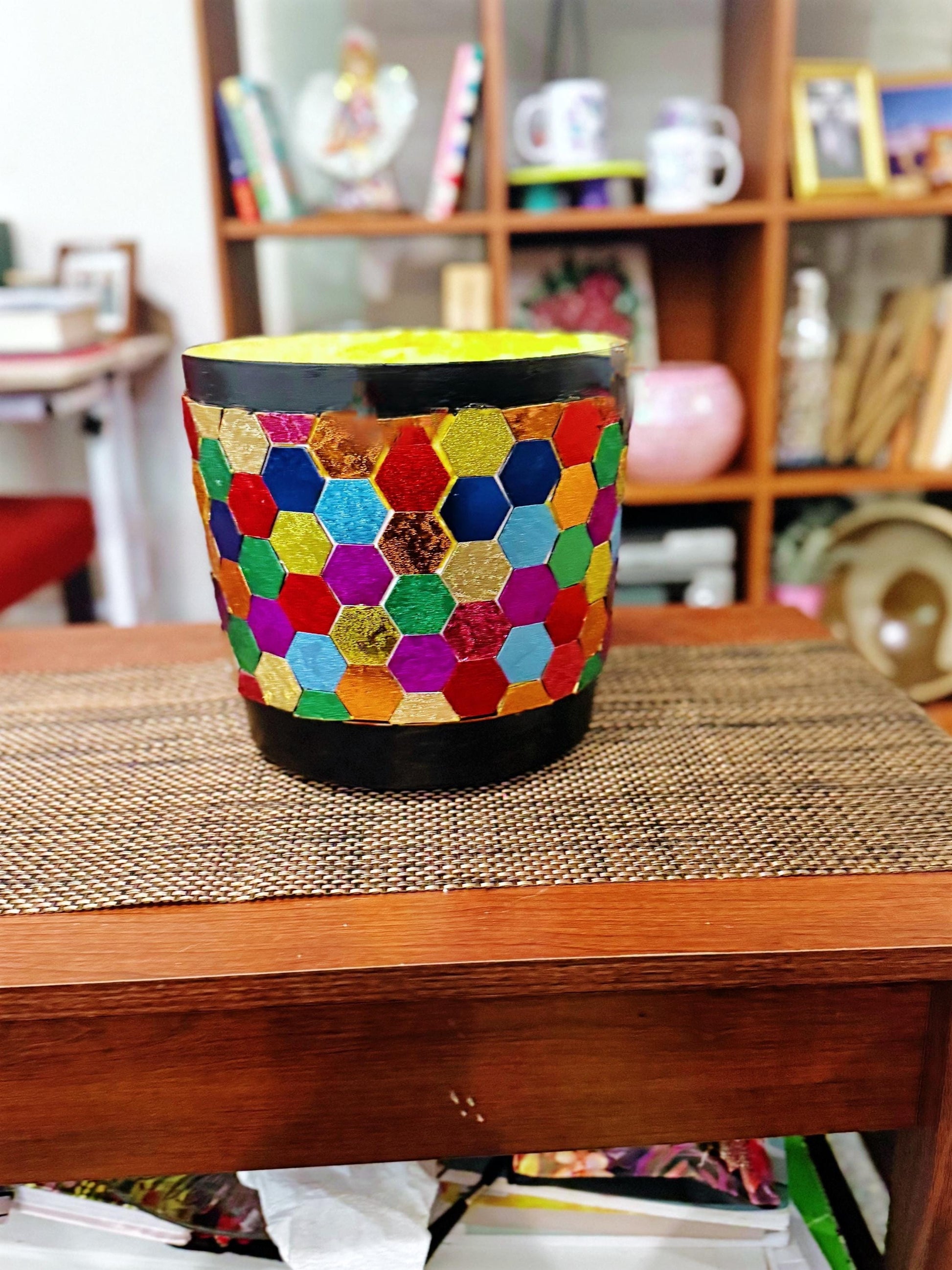 Colorful flower bouquet in a rainbow mosaic hexagon planter with lush greenery and vibrant blooms.