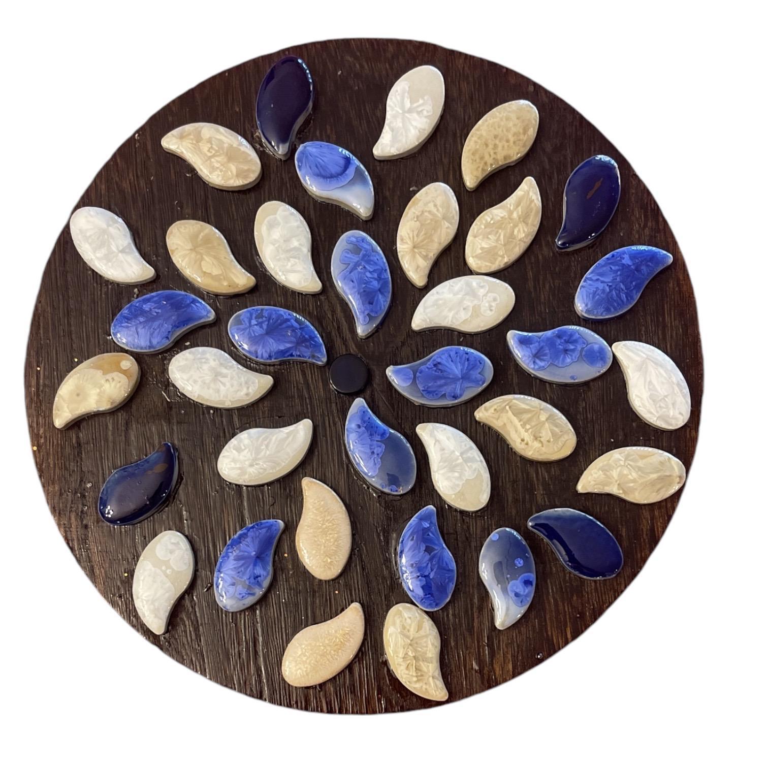 Handcrafted blue and white petal mosaic wooden plant stand with four legs, showcasing intricate tile design for indoor or outdoor use