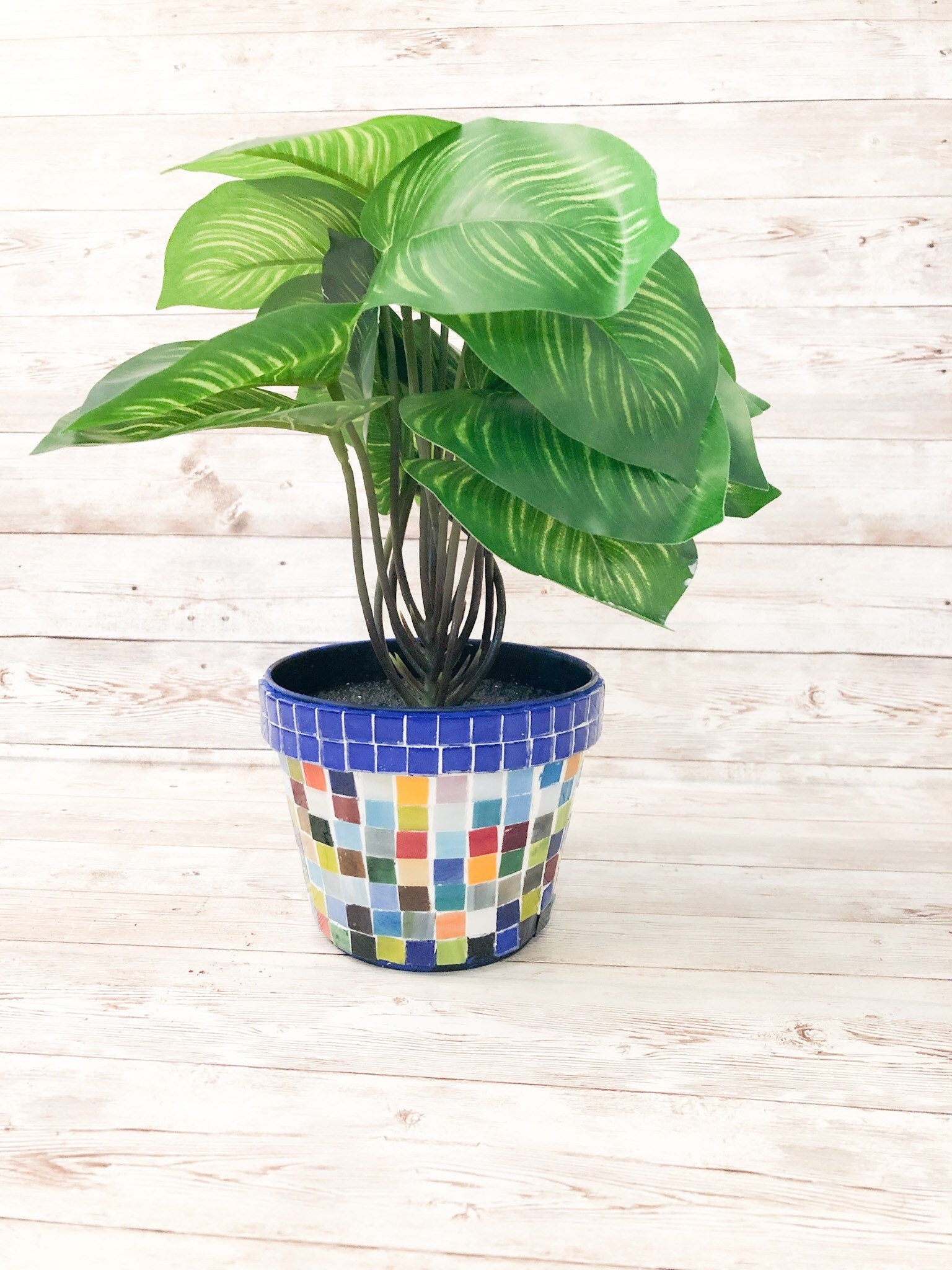 Colorful artisan rainbow mosaic planter with intricate tile design, perfect for indoor or outdoor decorative plants.
