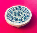 Handcrafted round turquoise glass mosaic plant riser with intricate tile pattern for decorative indoor or outdoor use