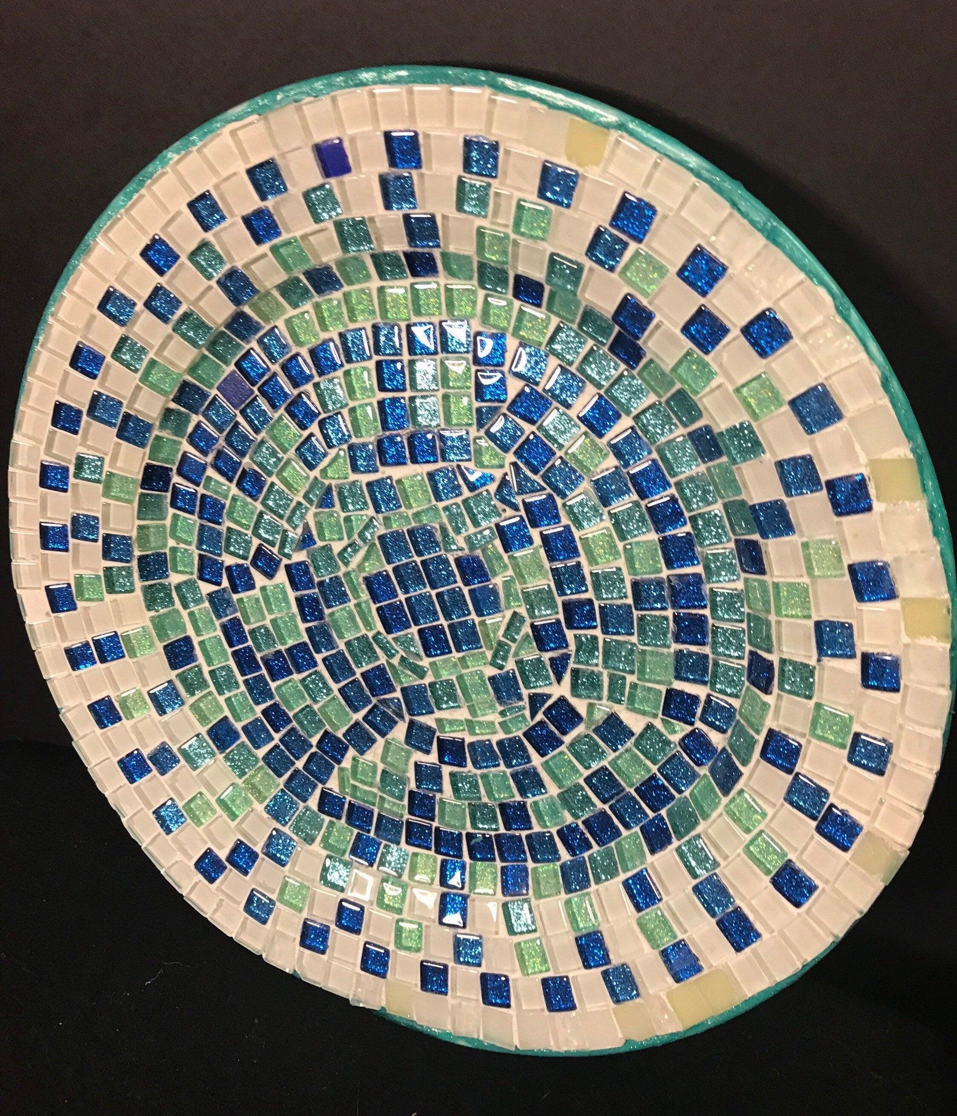 Iridescent turquoise mosaic glass wall art featuring colorful, reflective glass pieces arranged in an intricate pattern.