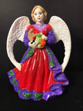 Hand-painted Harvest Angel figurine with detailed craftsmanship, featuring vibrant colors and intricate design.