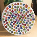 Handcrafted blue and amber mosaic plant stand with intricate tile design, perfect for displaying indoor plants.
