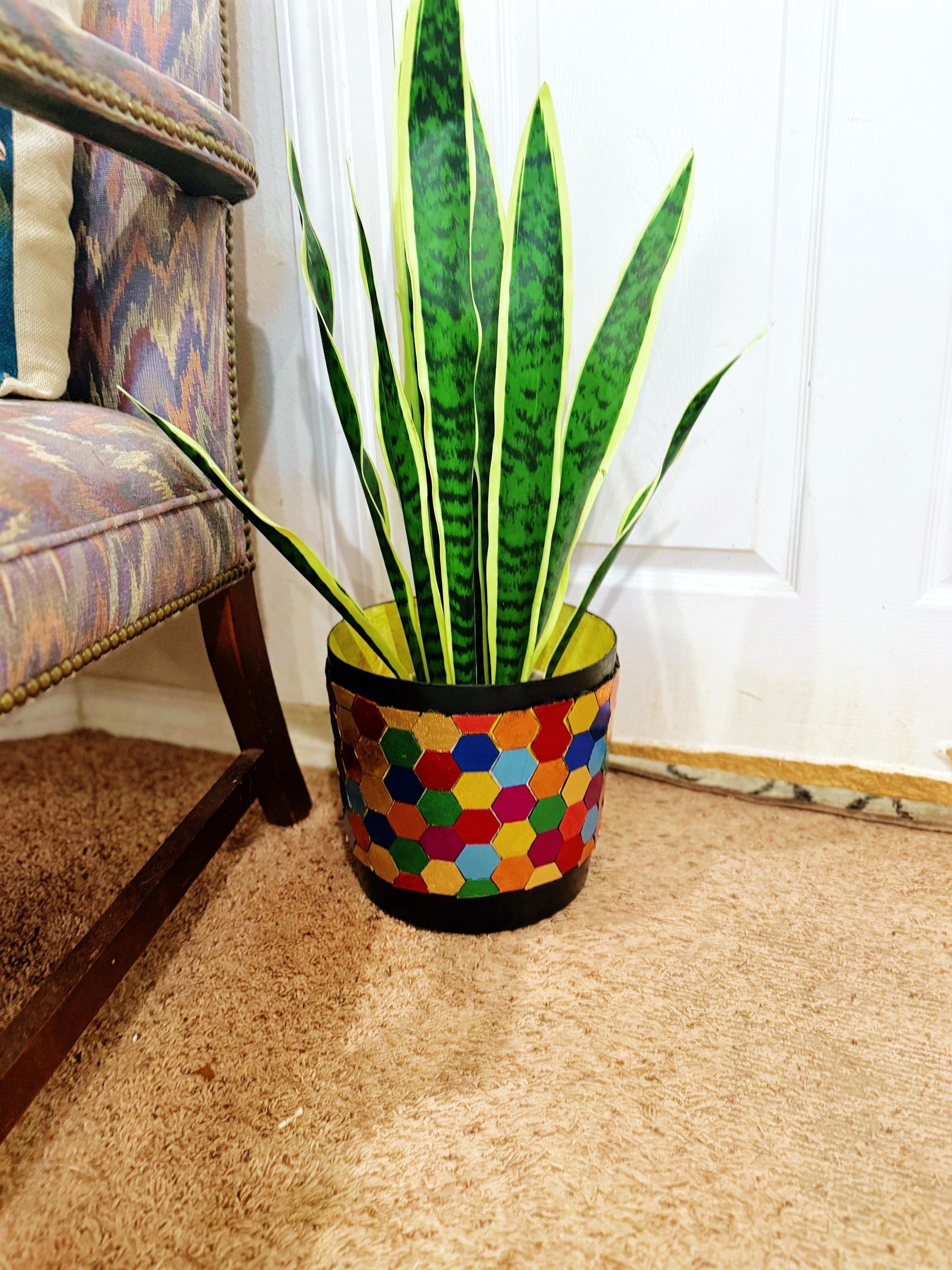 Colorful bouquet of mixed flowers in a rainbow mosaic hexagon planter, showcasing vibrant blooms and decorative ceramic design.