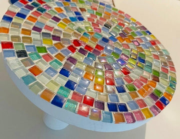 Handcrafted white rainbow mosaic plant stand with colorful tile design, perfect for displaying indoor or outdoor potted plants.