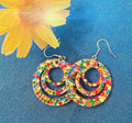 Multicolored crystal on wood hoop earrings with vibrant stones and natural wooden hoops, stylish jewelry accessory.