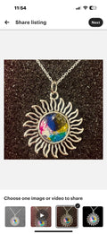 Multicolored glass Sunburst pendant necklace with silver chain, featuring vibrant stained glass design and intricate craftsmanship.