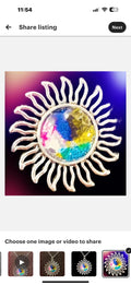 Multicolored glass sunburst pendant necklace with silver chain, featuring stained glass design and vibrant hues.