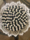 Handmade black and white iridescent mosaic plant stand with intricate pattern and sturdy base, perfect for indoor or outdoor plants.