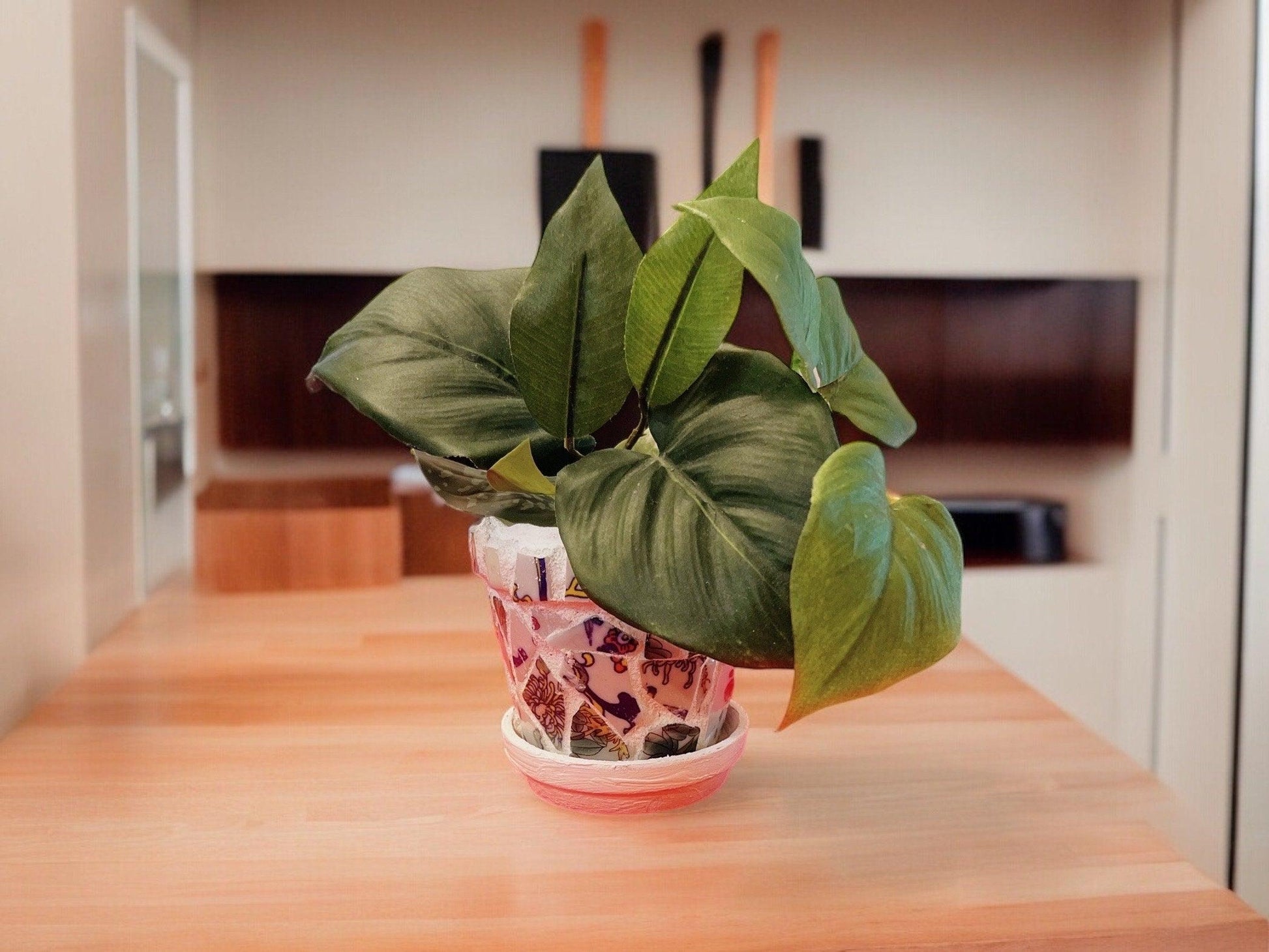 Handcrafted broken china mosaic planter with matching saucer, featuring colorful tile design for indoor or outdoor decor.
