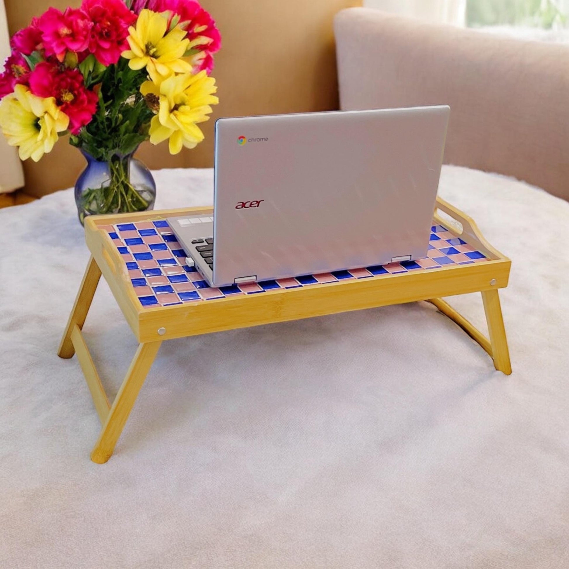 Handcrafted bamboo laptop tray with pink accents, designed for comfortable workspace and stylish organization.