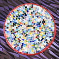 Vibrant handcrafted rainbow mosaic decorative plate with colorful glass pieces and intricate pattern.