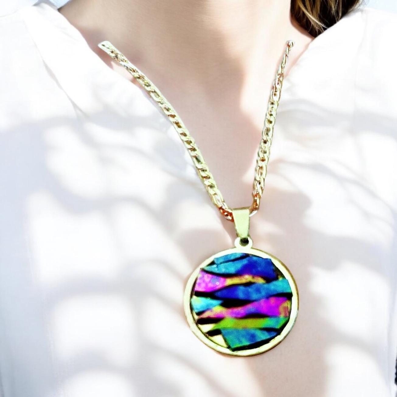 Colorful pendant necklace with vibrant beads and silver chain, showcasing a stylish and eye-catching jewelry piece