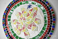 Artisan handcrafted round mosaic decorative plate with colorful tile patterns, ideal for wall display or as a decorative piece