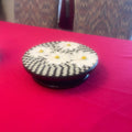 Colorful daisy floral mosaic art cake plate with intricate floral design on white ceramic, perfect for serving desserts.