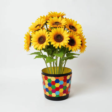 Colorful flower bouquet in a rainbow mosaic hexagon planter, featuring vibrant blooms and geometric design.