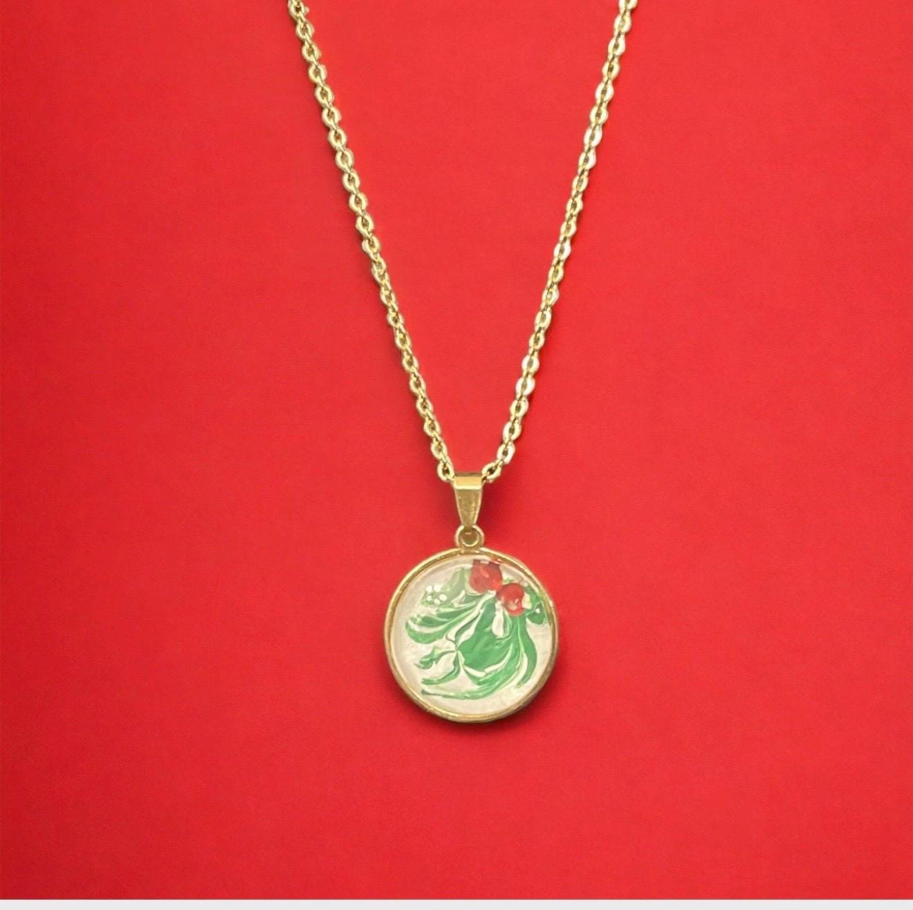 Christmas Holly Pendant Necklace with green holly leaves and red berries, silver-tone chain, festive holiday jewelry.