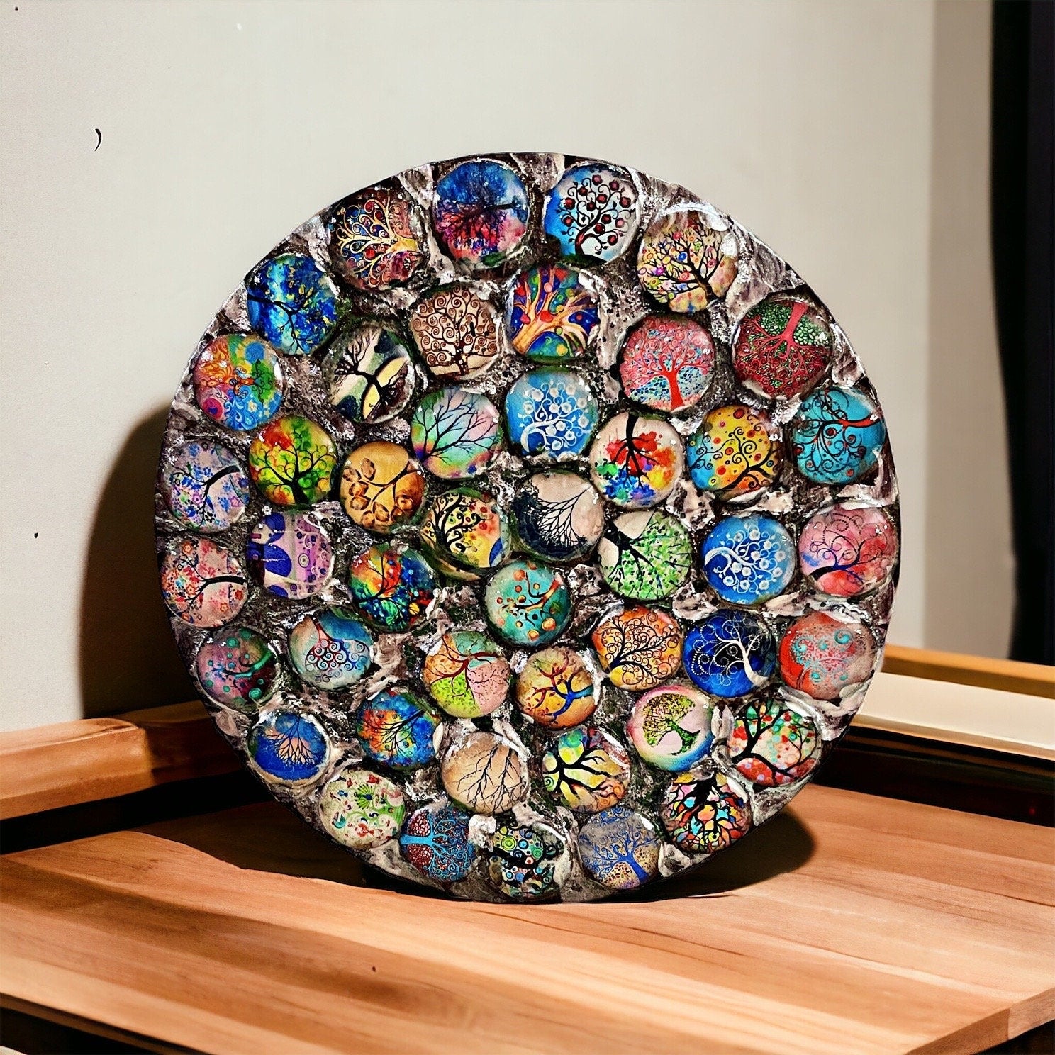 Handcrafted Tree of Life mosaic plant stand with colorful glass tiles, sturdy metal frame, designed for indoor or outdoor plants.