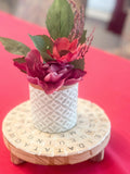 Decorative plant stand featuring a word game design, perfect for displaying indoor plants in a modern, stylish way.