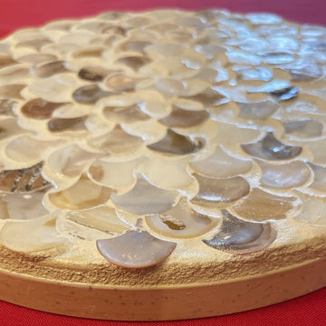 Handmade mother of pearl scallop mosaic decorative stand with intricate shell pattern and elegant design.