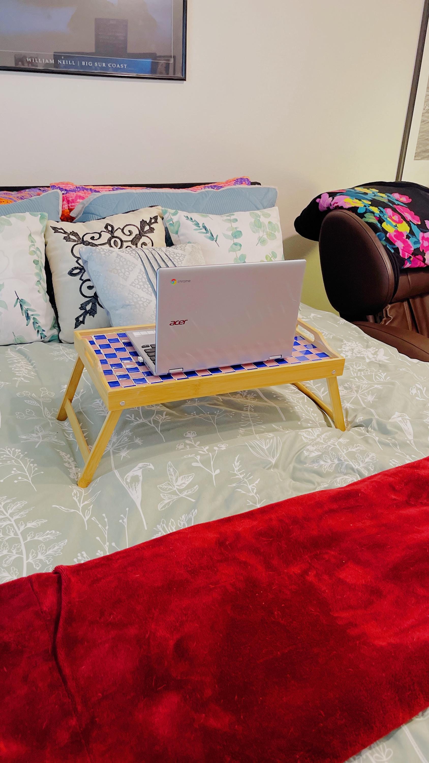 Handcrafted bamboo laptop tray with pink accents, designed for comfortable workspace and portable use.