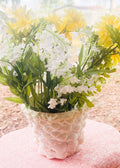 Handcrafted seashell mosaic plant pot with intricate shell patterns, ideal for indoor or outdoor decorative gardening.