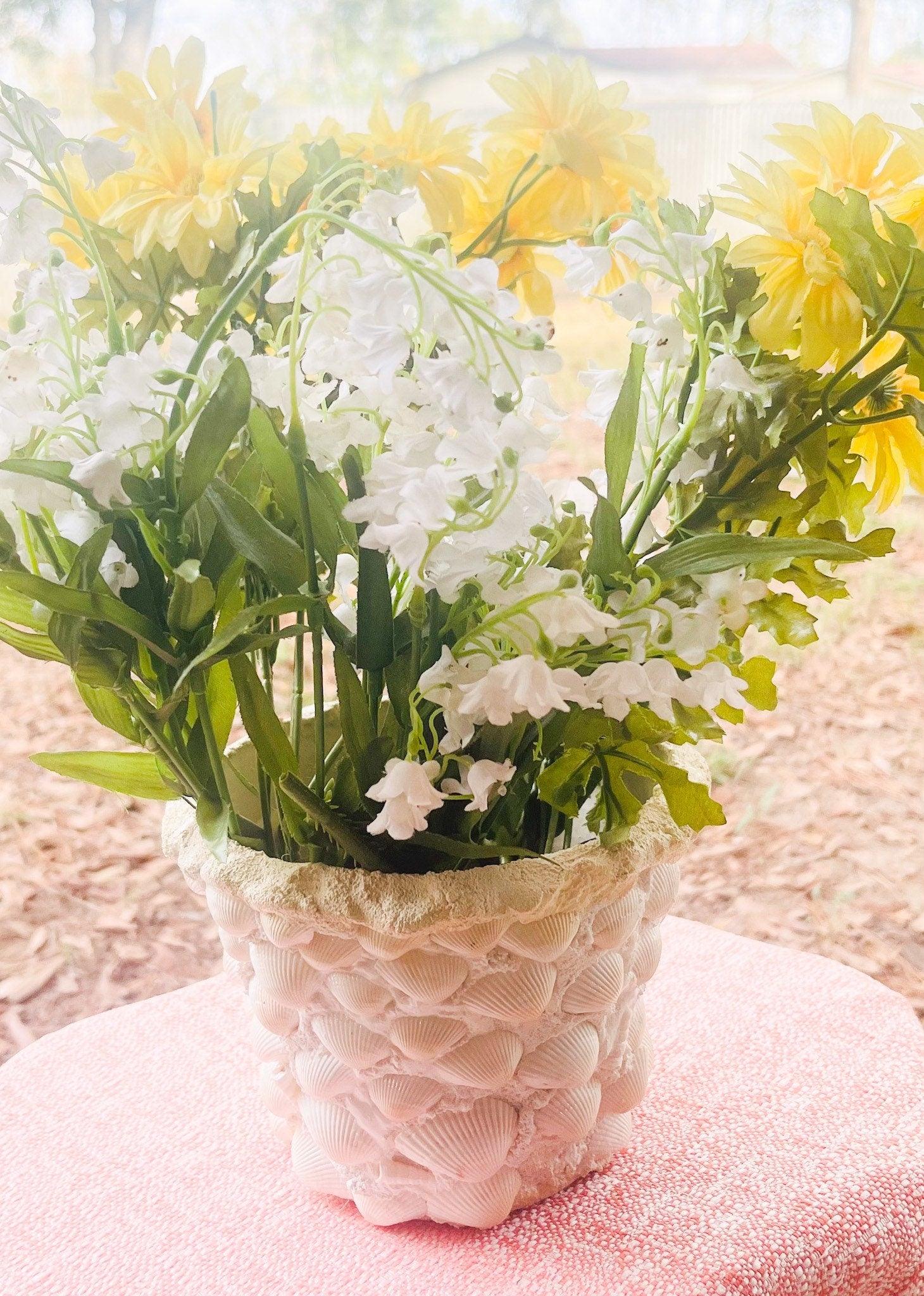 Handcrafted seashell mosaic plant pot with intricate shell patterns, ideal for indoor or outdoor decorative gardening.