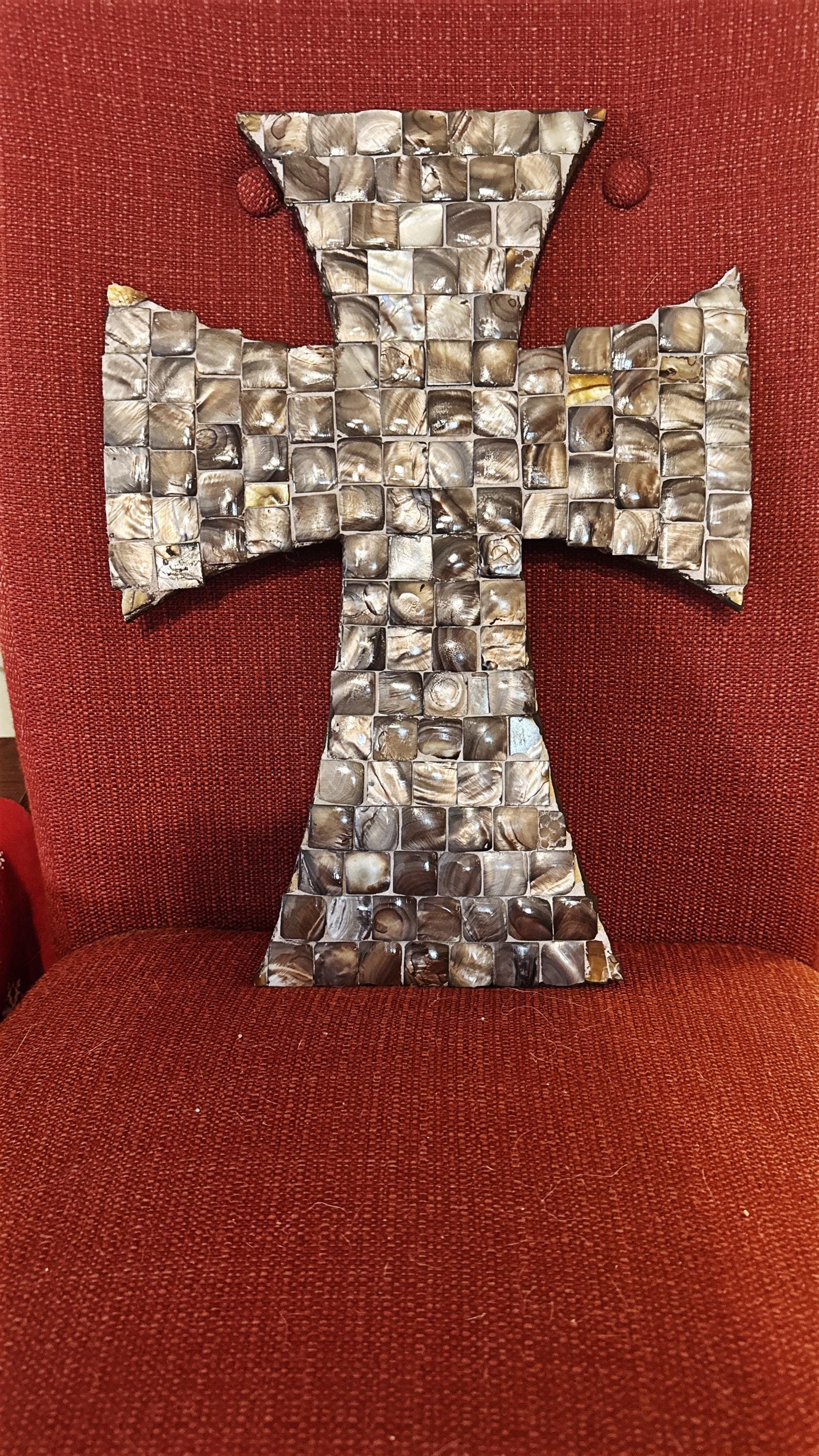 Mother of Pearl mosaic cross with intricate inlay, showcasing shimmering pearl tiles and detailed craftsmanship.