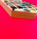 Colorful handcrafted mosaic cross with multicolor tiles, showcasing intricate design and artistic craftsmanship.