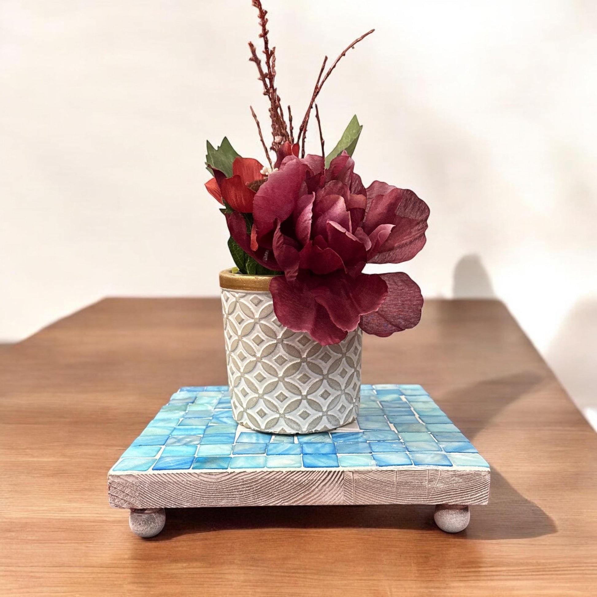 Handcrafted square turquoise plant stand with a sturdy design, perfect for displaying indoor or outdoor plants.