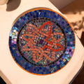 Handcrafted round mosaic wall art featuring colorful ceramic tiles, perfect for decorative indoor or outdoor wall display.