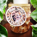 Handmade eucalyptus scented candle in a gold mosaic glass jar, held in hand, showcasing artisanal craftsmanship and elegant design.