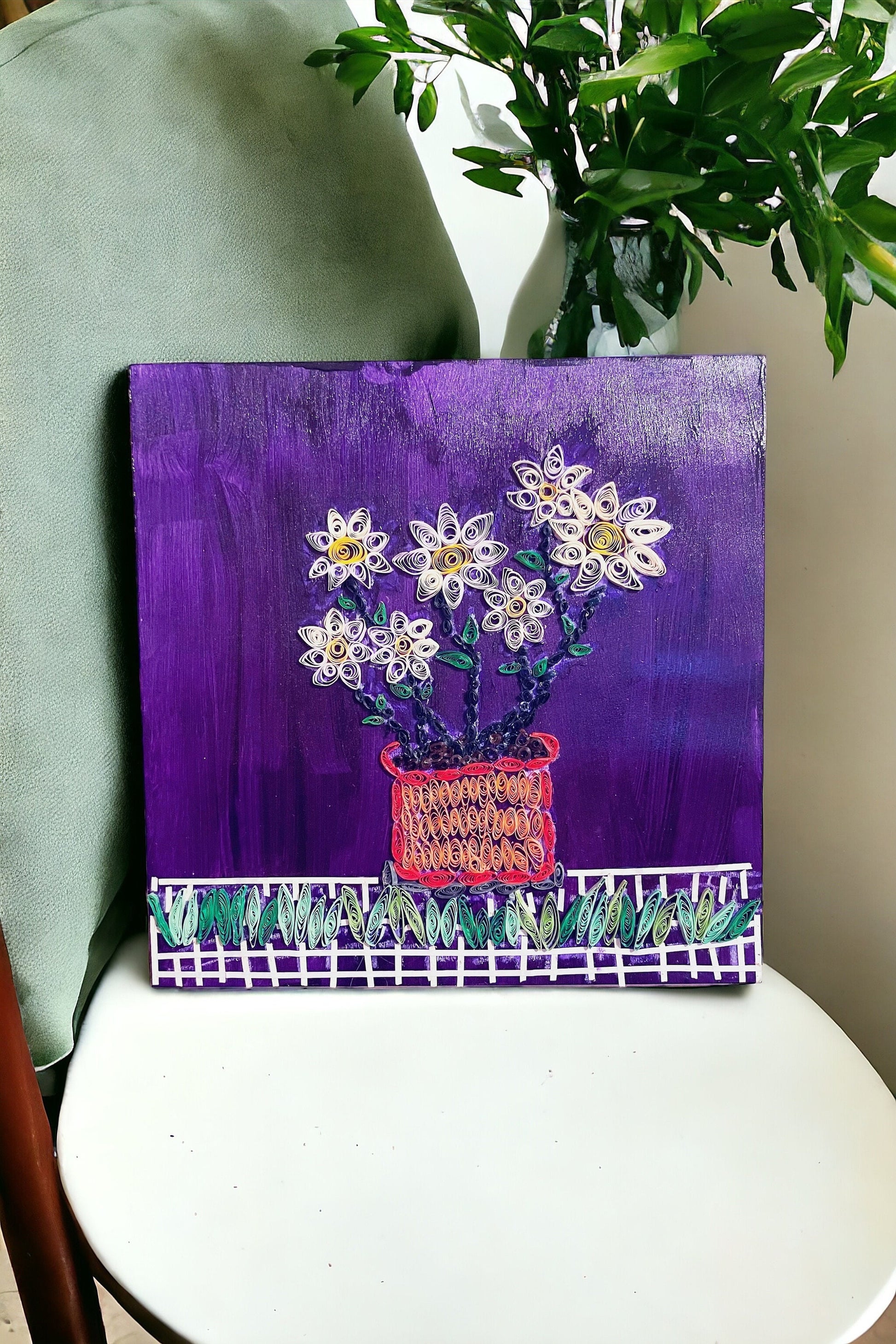 Original paper quilling artwork of a flower pot, featuring intricate paper coil designs and vibrant colors.