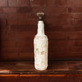 Handcrafted shell glass carafe with decorative bottle stopper by Miss Bette's Creations, featuring elegant design and clear glass.