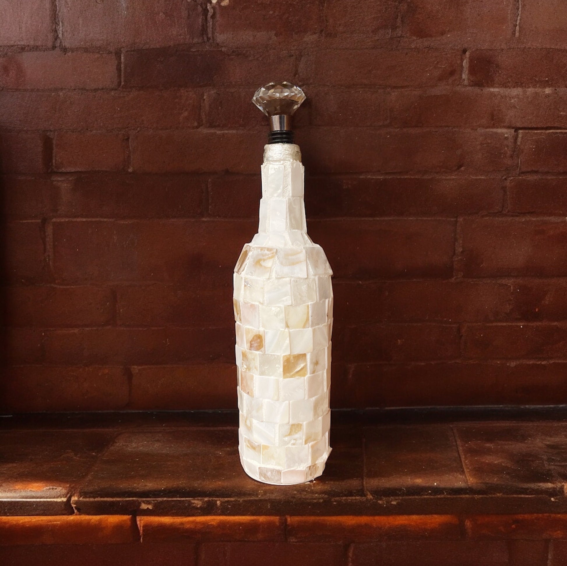Handcrafted shell glass carafe with decorative bottle stopper by Miss Bette's Creations, featuring elegant design and clear glass.