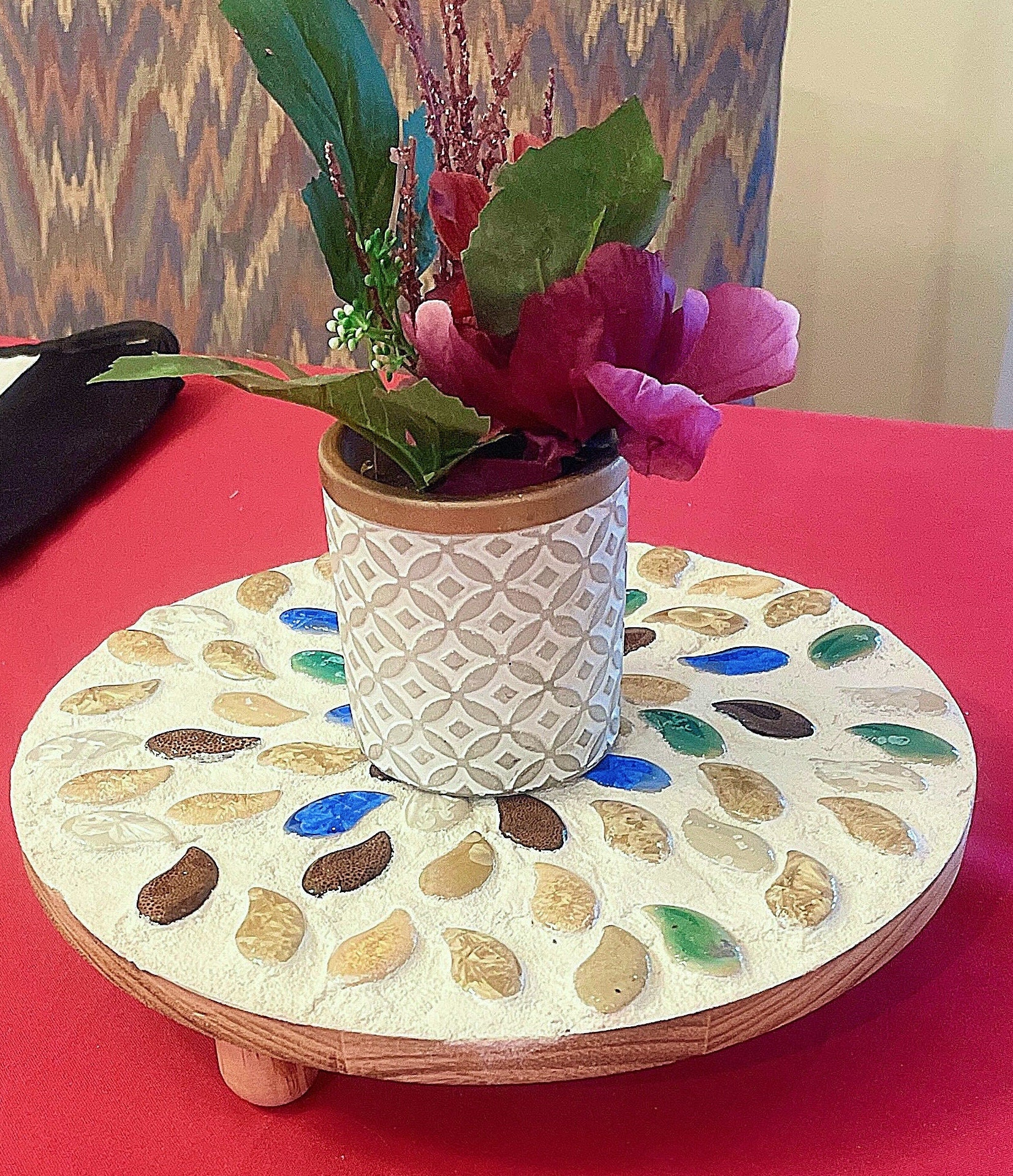 Handcrafted earth tone mosaic plant stand with multiple tiers, featuring colorful mosaic tiles and sturdy metal frame.