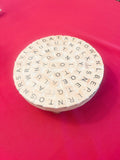 Decorative plant stand with a word game design, ideal for showcasing plants as stylish home decor.
