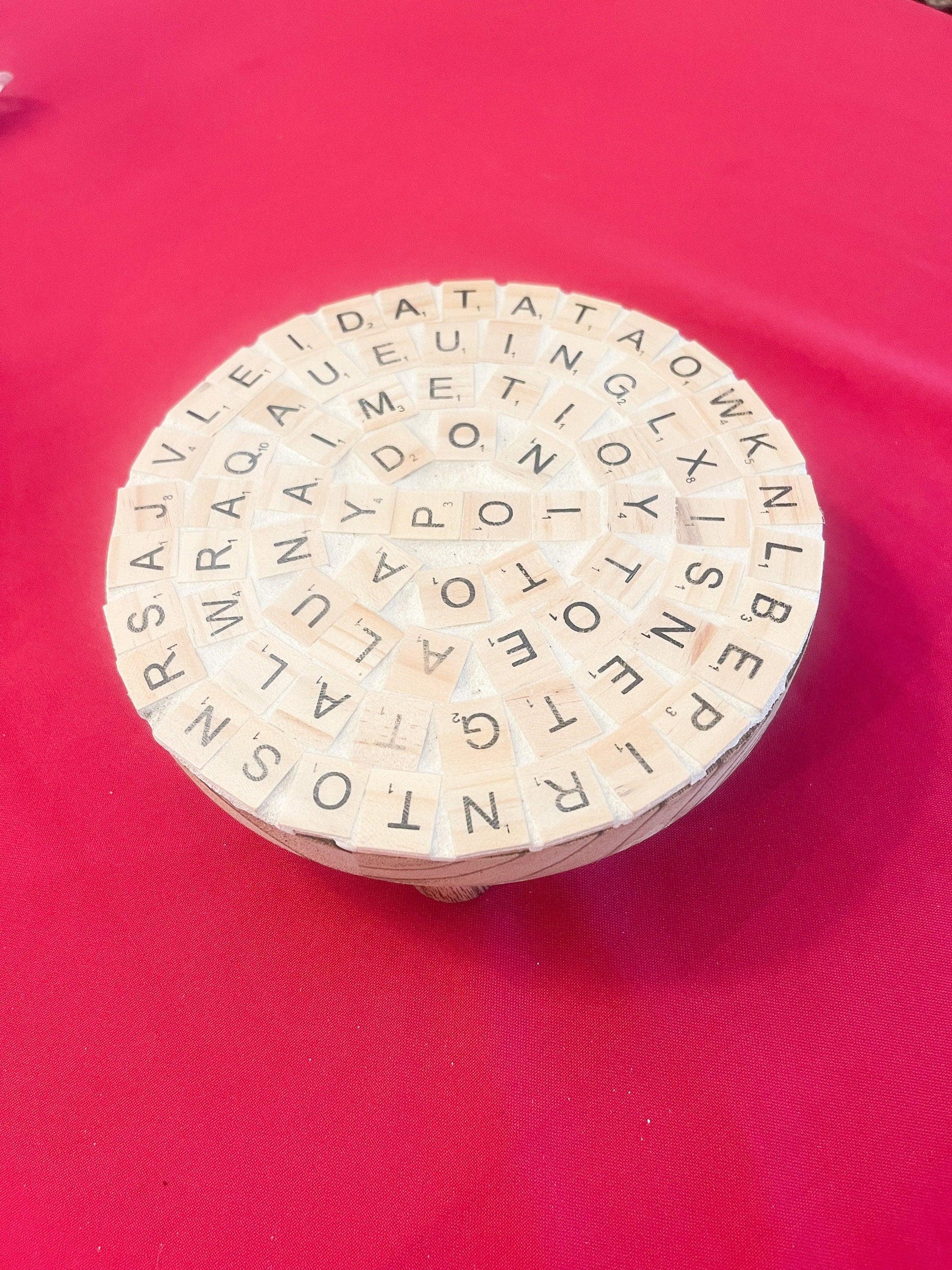 Decorative plant stand with a word game design, ideal for showcasing plants as stylish home decor.