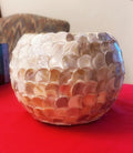 Handcrafted scalloped capiz shell globe vase with a smooth, round design and intricate shell details for elegant decor.