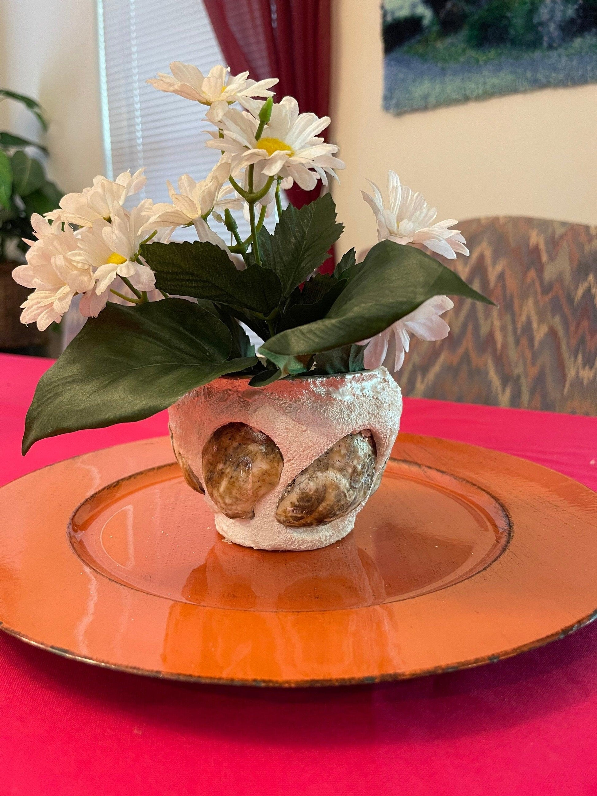 Handcrafted seashell and sandstone mini planter with natural textures, ideal for small plants or succulents.