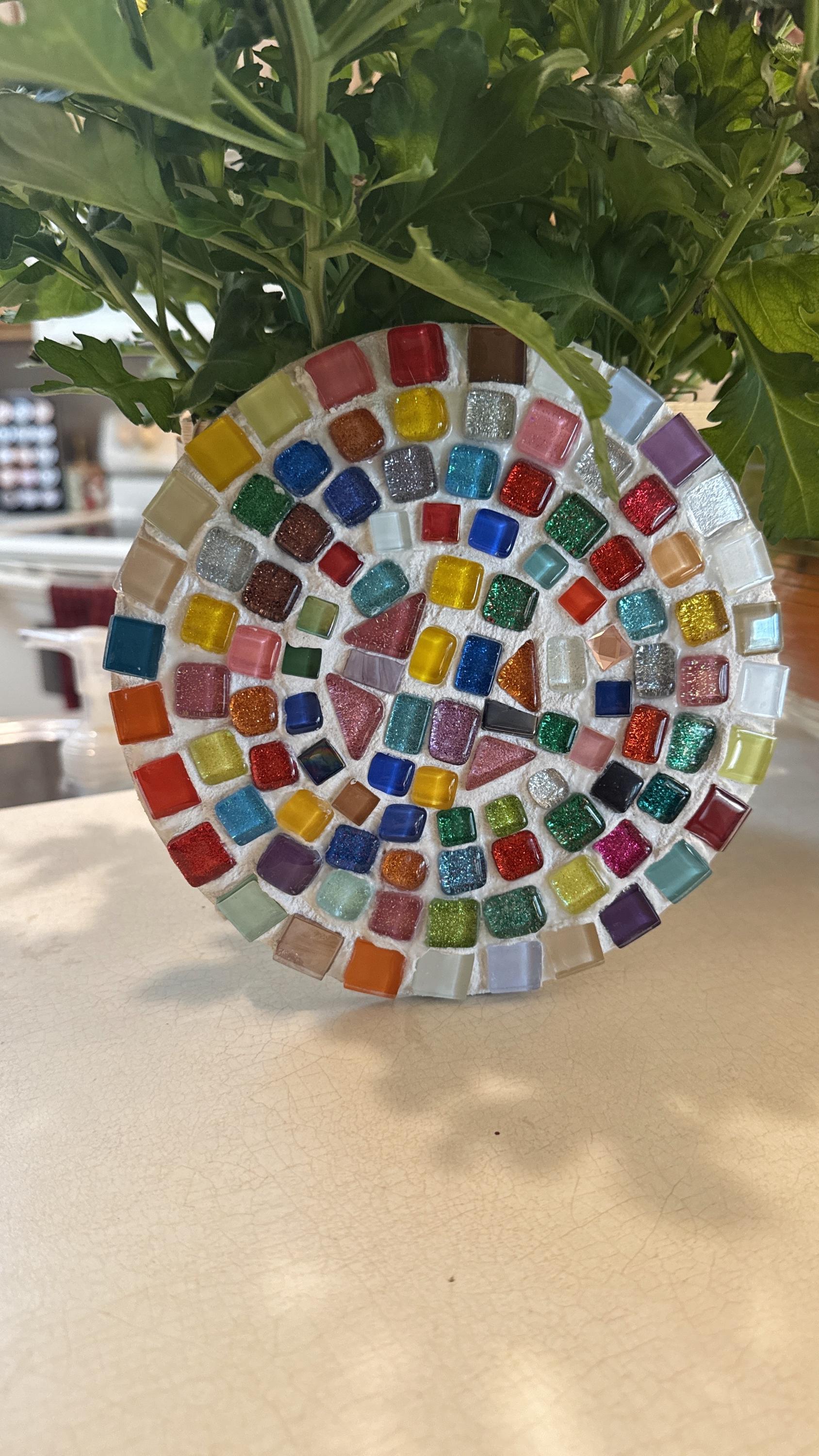 Handcrafted blue and amber mosaic plant stand with intricate tile design, ideal for displaying potted plants indoors or outdoors.