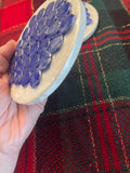 Blue marble mosaic coaster with artisanal design, featuring intricate blue and white stone patterns for decorative use.