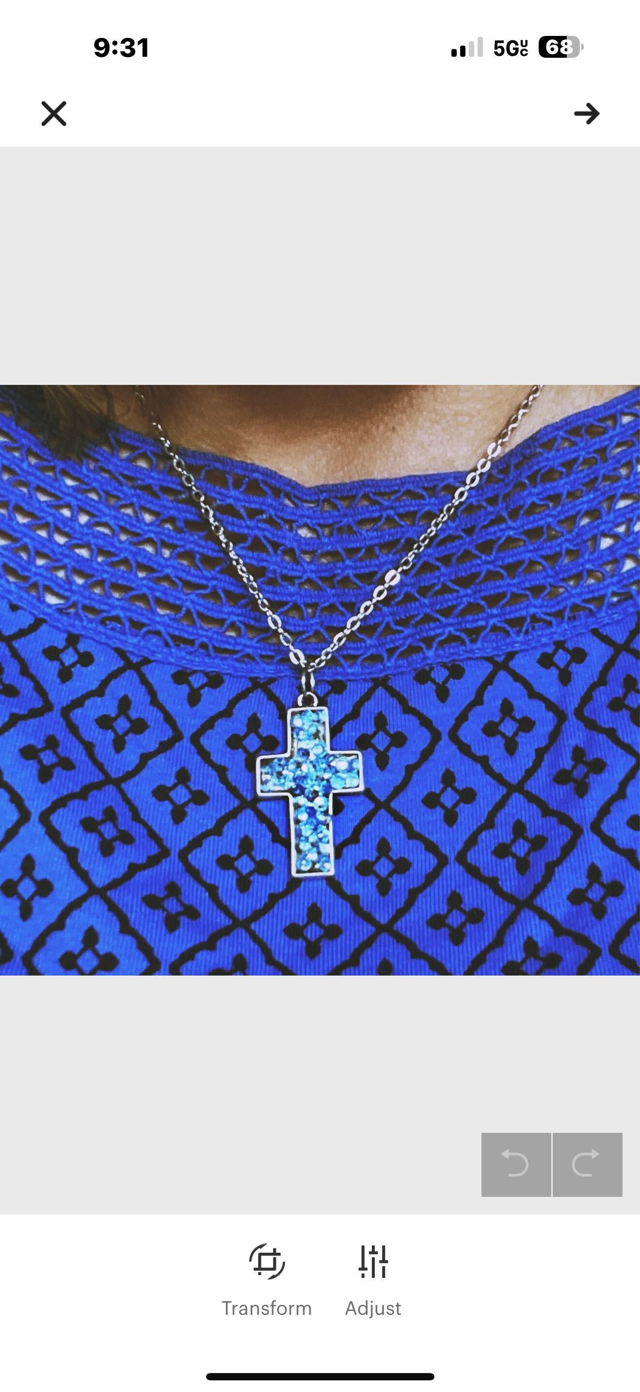 Handcrafted crushed crystal cross necklace with silver chain, featuring sparkling crystal details on a delicate pendant.