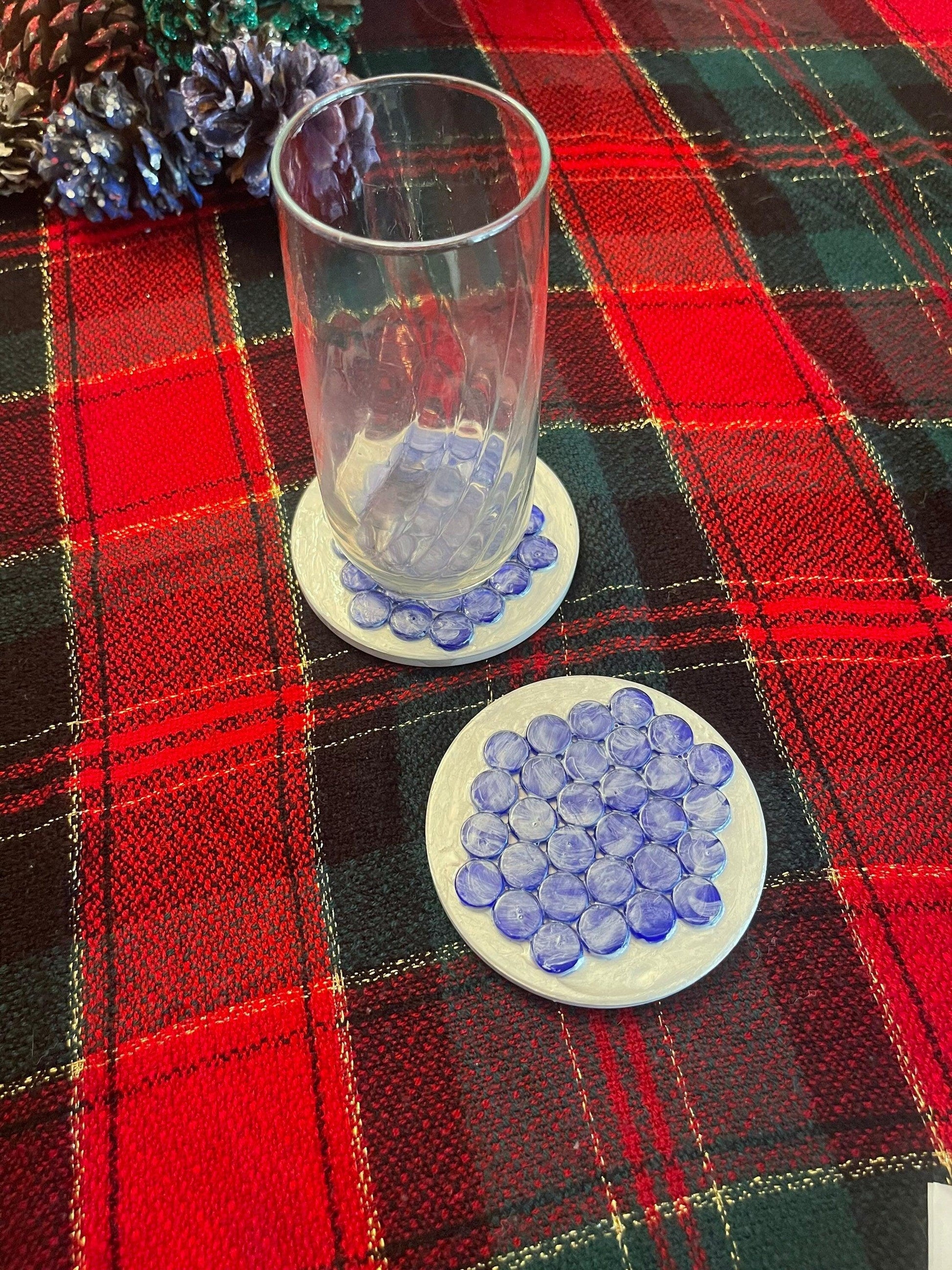 Artisanal blue marble mosaic coaster featuring intricate pattern and polished finish, perfect for protecting surfaces.