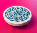Handcrafted round turquoise glass mosaic plant riser with intricate tile design and sturdy base for elevating potted plants.